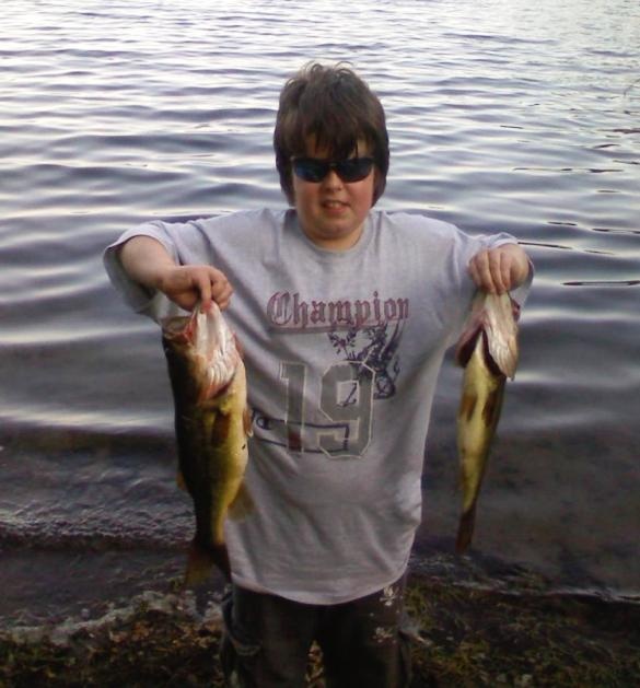 nicholas with his 2 biggest bass to date